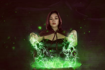 Asian girl witch with red cloak preparing a magic potion